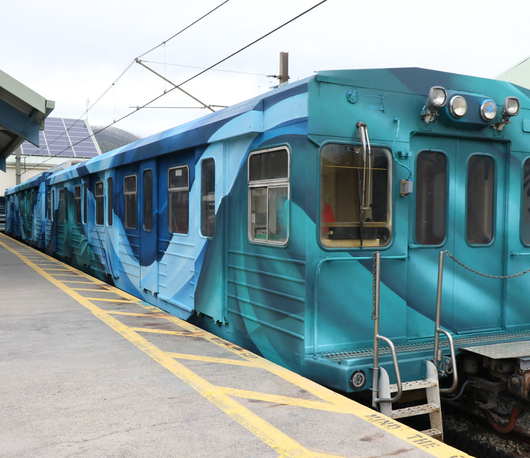 Ski Tube Carriage Front Front section of the Ski Tube train with blue abstract artwork at the station.