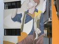 Warry Street Brisbane mural of an elderly man holding a paper plane and cane, painted on a building wall