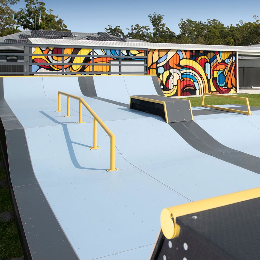 Backyard skate ramp with colourful shed mural painted in Glass House Mountains by Mike Shankster
