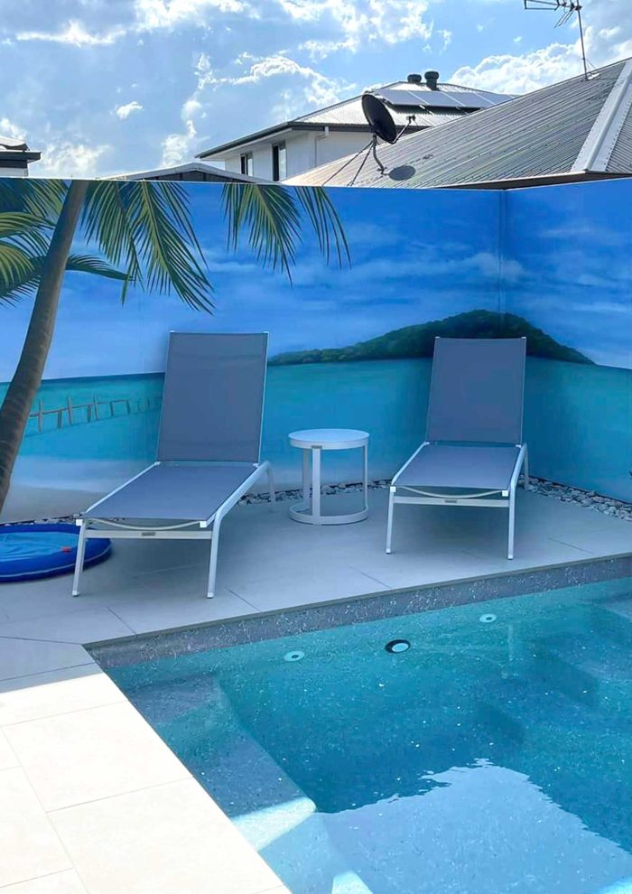 Gold Coast pool mural with beach scene painted on a backyard fence