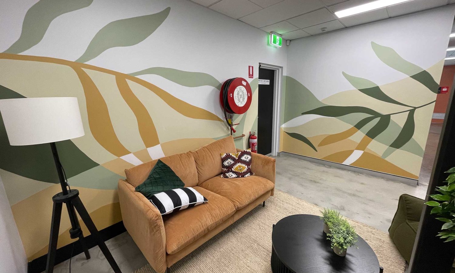 Abstract floral office mural painted in earthy colours for a shared Gold Coast workspace