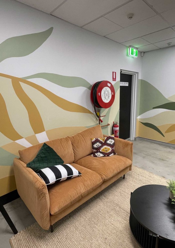 Gold Coast office mural with abstract floral shapes in sage green, olive, ochre and neutral earthy colours