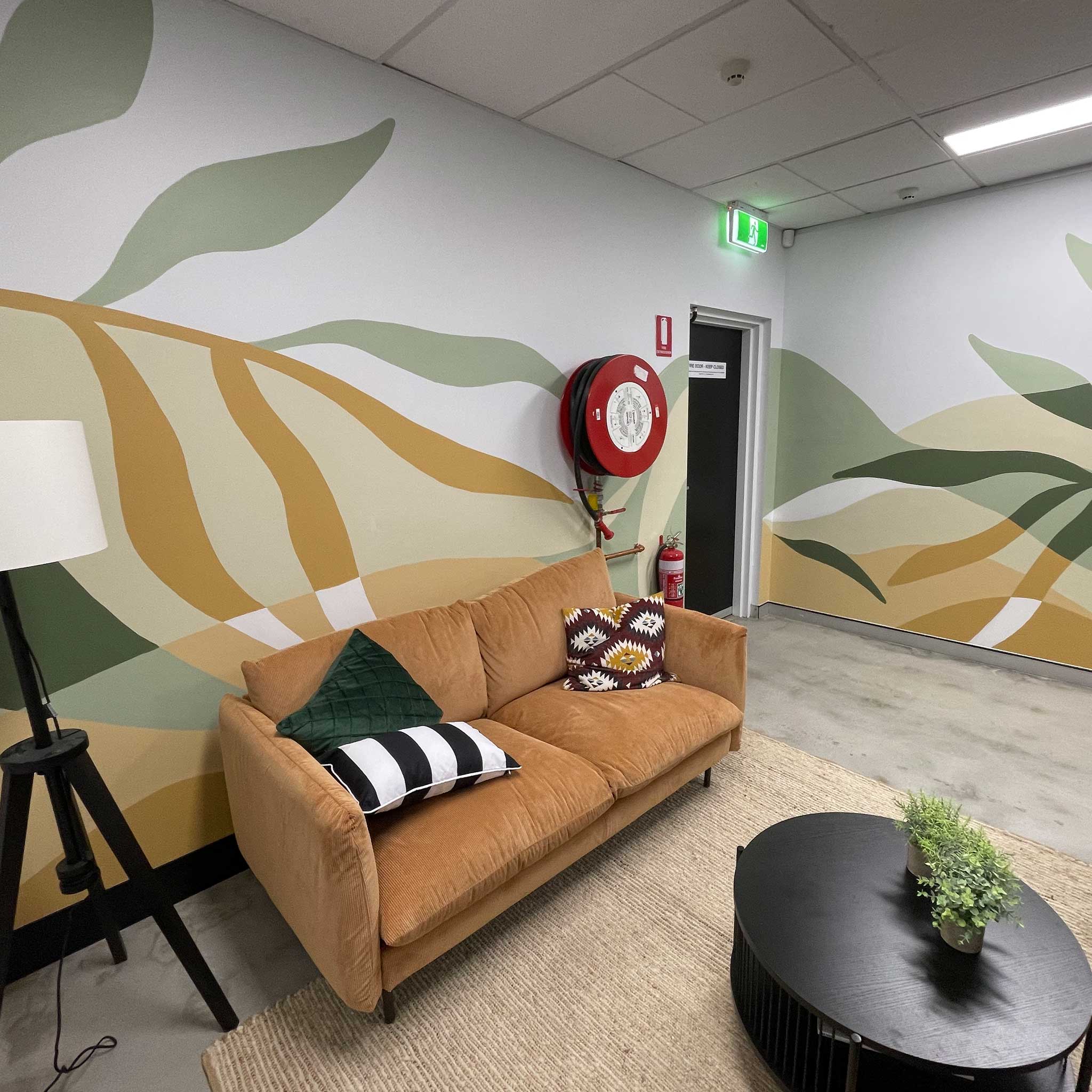 Gold Coast office mural with abstract floral shapes in sage green, olive, ochre and neutral earthy colours