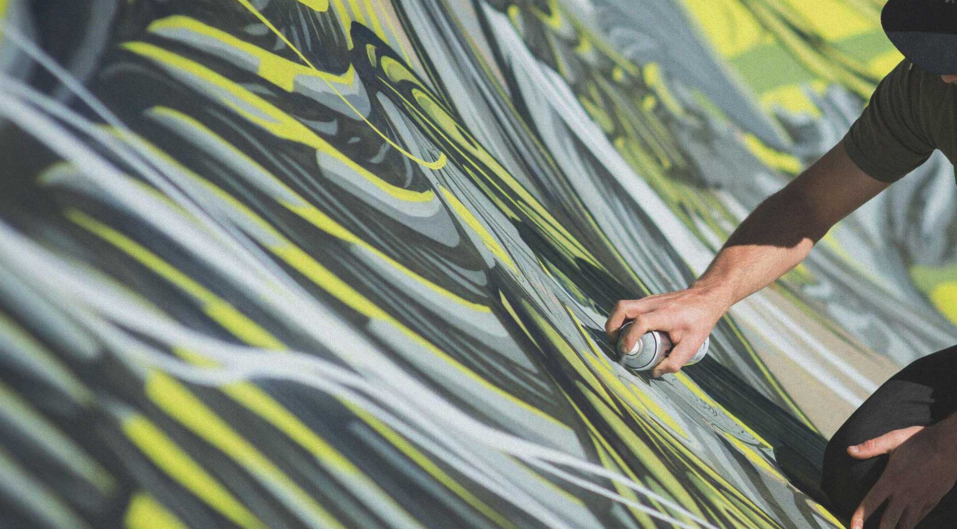 Mike Shankster painting a large-scale mural with spray paint