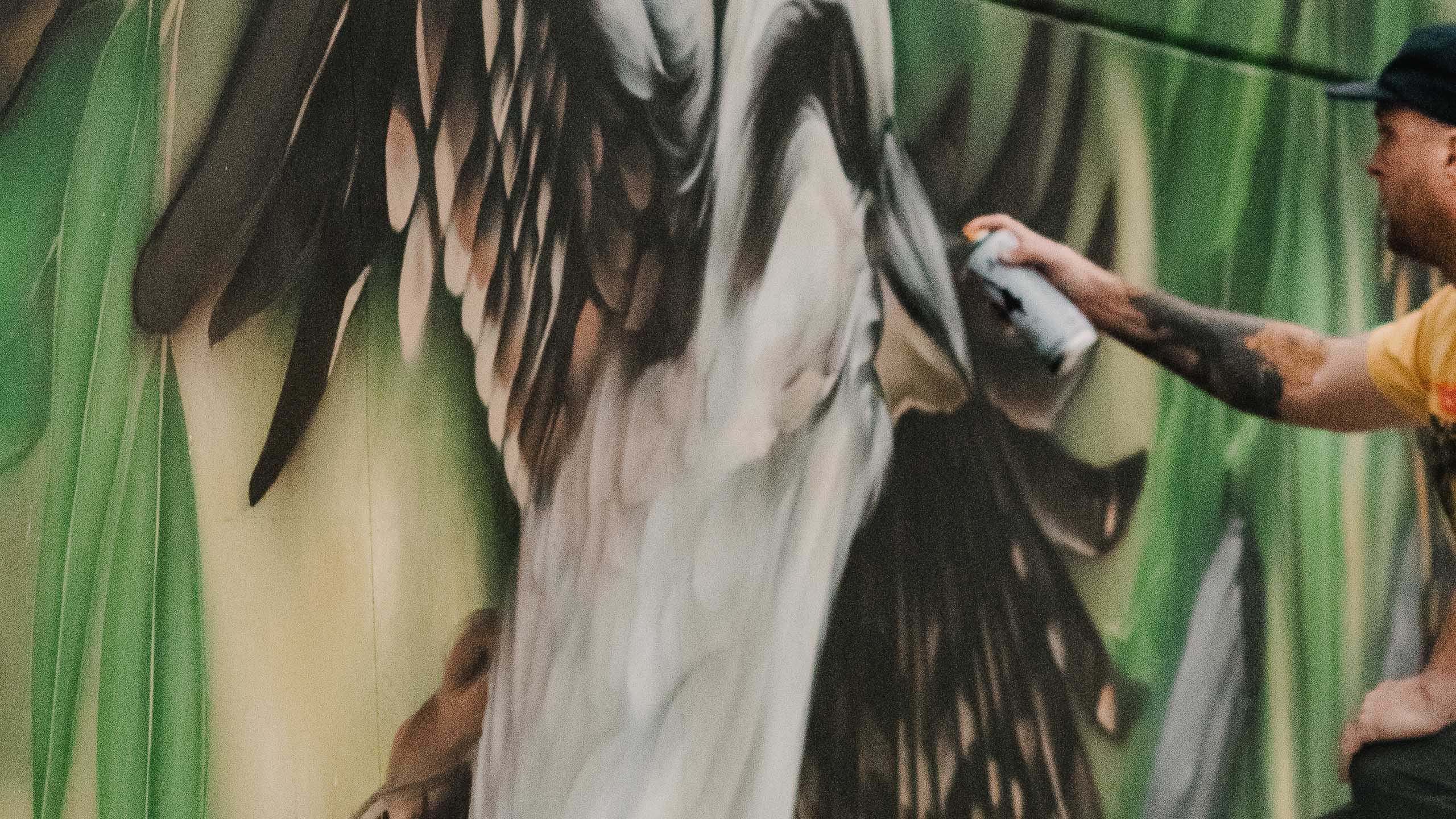 Mike Shankster painting a large-scale mural with spray paint